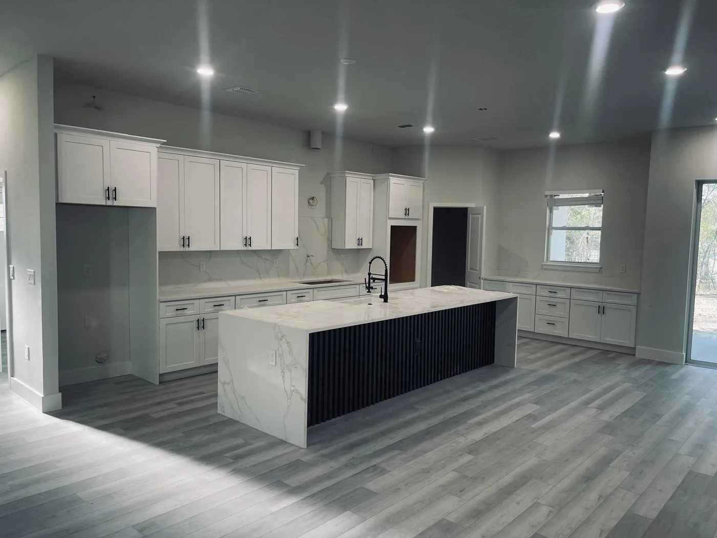 St. Cloud kitchen with a white island and a stone perimeter counter